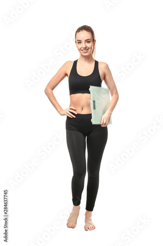 Young woman with scales on white background. Weight loss concept