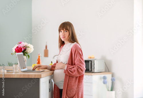 Pregnant Woman Using Laptop...