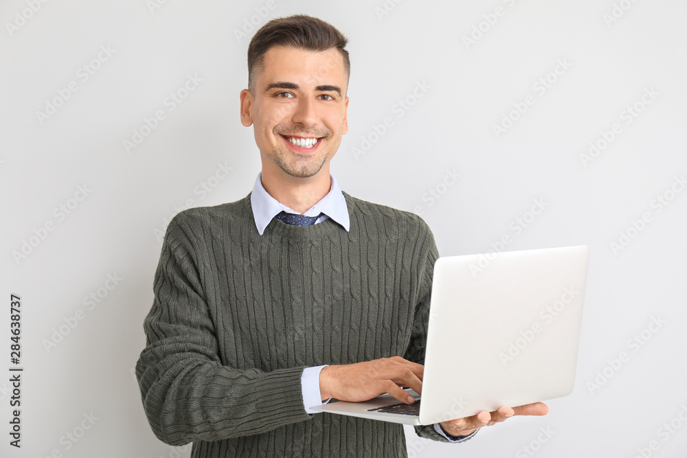 Handsome male teacher with laptop on white background Handsome male teacher with laptop on white background