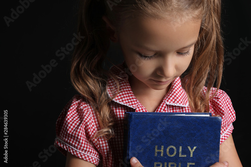 Cute little girl with Bible...