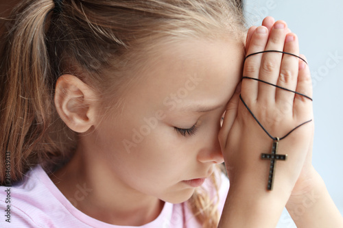 Praying little girl at home...