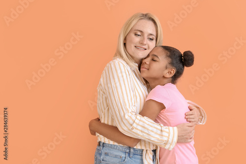 Happy woman hugging her Afr...
