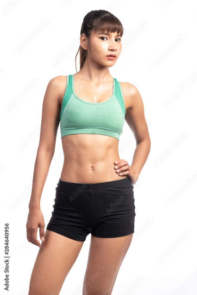 Fitness woman white background. Asian woman. Hands on hip. Looking at camera. Fitness woman white background. Asian woman. Hands on hip. Looking at camera.