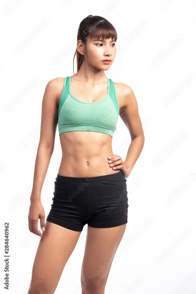 Fitness woman white background. Asian woman. Hands on hip, looking confident.