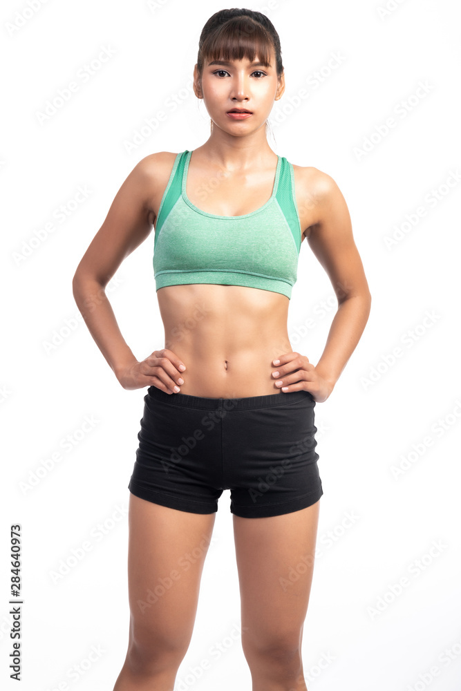 Fitness woman white background. Asian woman. Hands on hip, looking very confident. Fitness woman white background. Asian woman. Hands on hip, looking very confident.