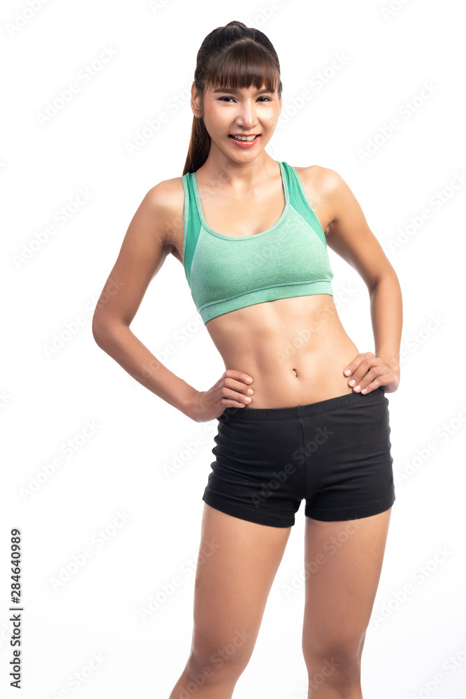 Fitness woman white background. Asian woman. Hands on hip, with a great smile on her face. Fitness woman white background. Asian woman. Hands on hip, with a great smile on her face.