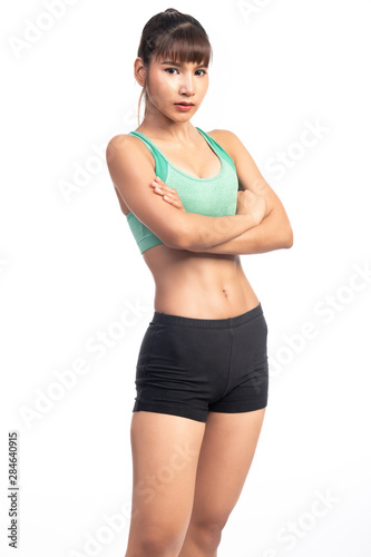 Fitness woman white background. Asian woman. Arm cross, confident look. © Baan Taksin Studio