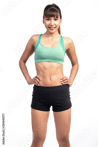 Fitness woman white background. Asian woman. Hands on hip, happy smile.