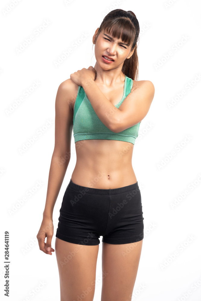 Fitness woman in pain. Asian girl, rubbing her shoulder, extremely painful face. Fitness woman in pain. Asian girl, rubbing her shoulder, extremely painful face.