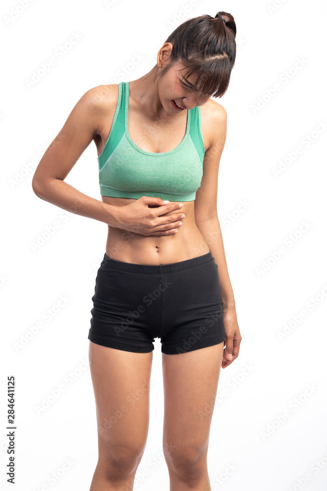 Fitness woman in pain. Asian girl, holding her stomach as it hurts. Fitness woman in pain. Asian girl, holding her stomach as it hurts.