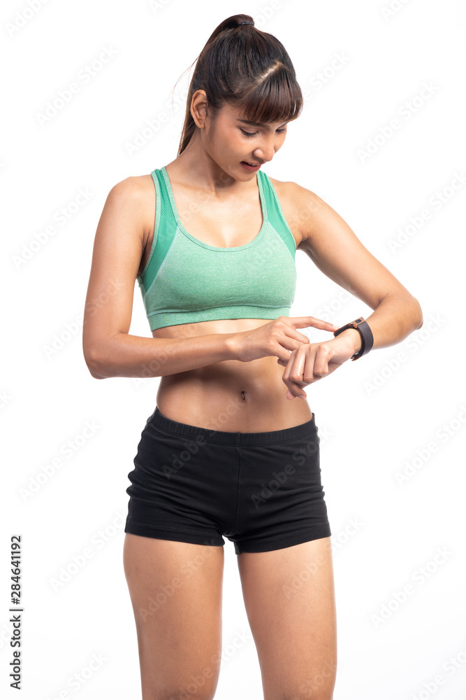 Fitness woman using smart watch isolated in white background. Asian girl, lookng at her watch. Fitness woman using smart watch isolated in white background. Asian girl, lookng at her watch.