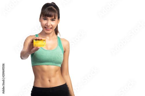 Fitness woman holding credit card isolated in white background. Asian girl  happy smile  with copy space.