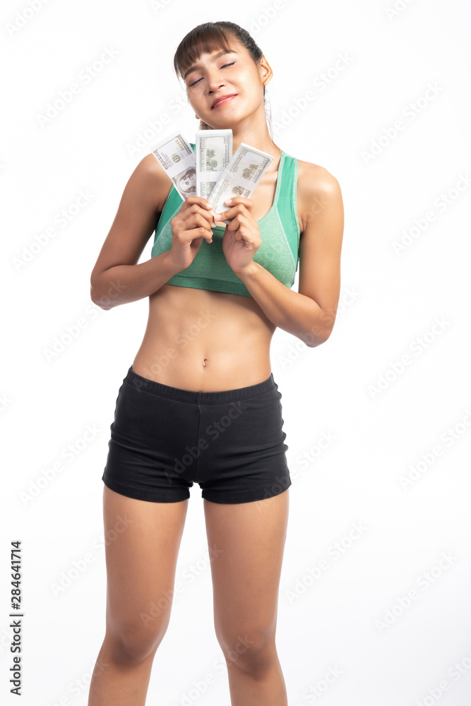 Fitness woman holding cash in hand isolated in white background. Asian girl, happy thought. Fitness woman holding cash in hand isolated in white background. Asian girl, happy thought.