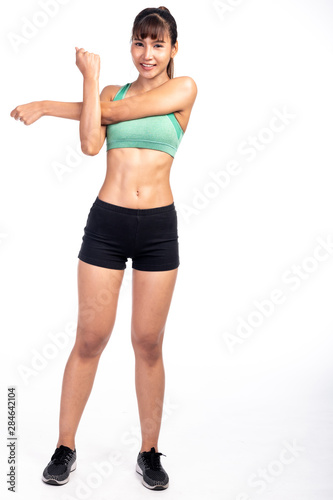 Fitness woman stretching isolated in white background. Asian girl in full body shot. Left arm stretch.
