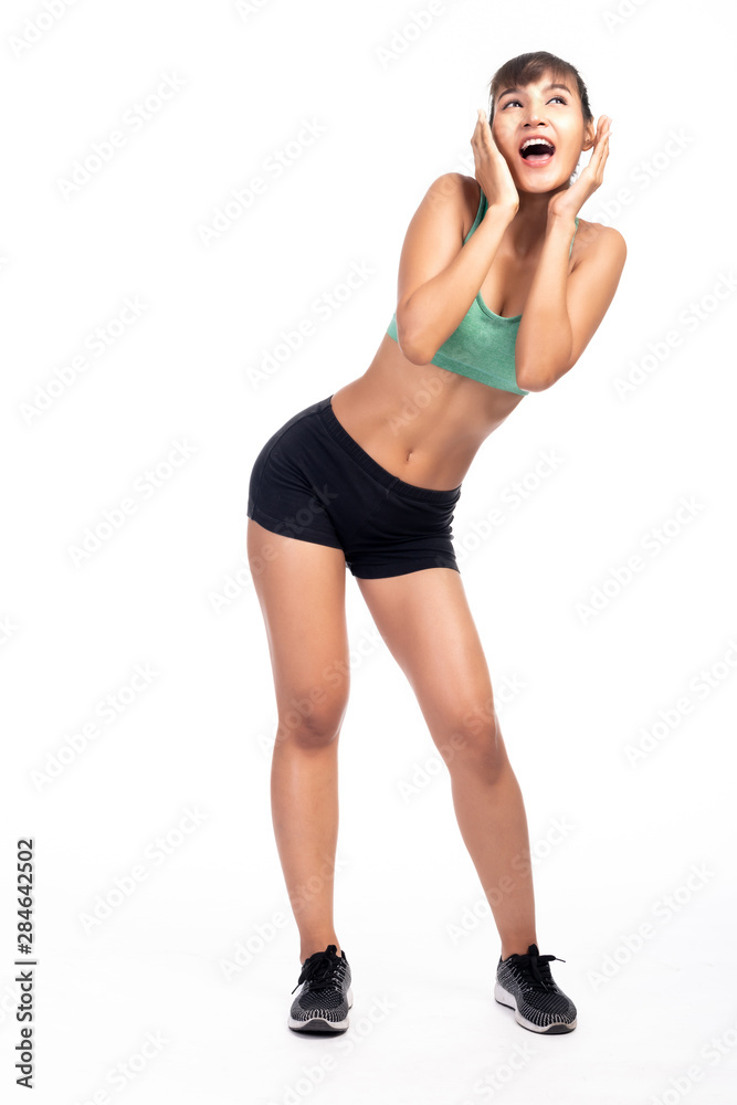 Fototapeta premium Fitness woman white background. Asian woman. Full body shot, hand on face looking very happy.