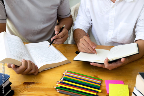 Students helps friend teaching and learning subject additional in library. Education concept. photo