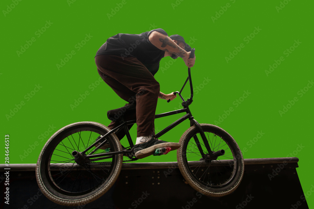 Naklejka premium BMX rider on green screen.