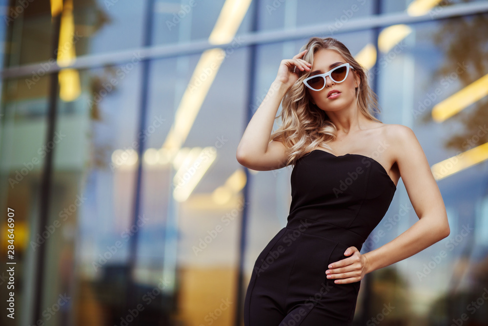 Fashion portrait of a young woman in a black suit