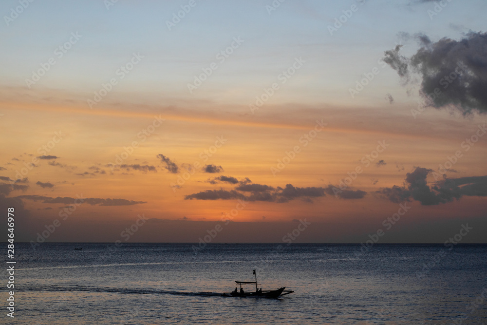 A traditional small fishing boat sailing in the ocean
