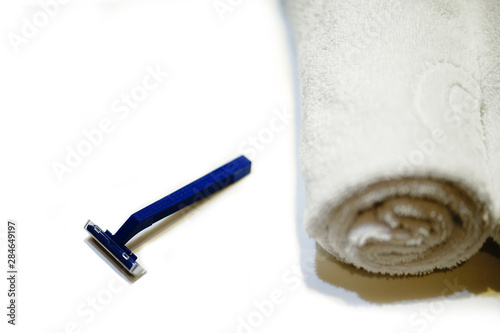 Razor blade, on white background with towel       