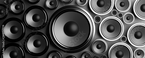 Multiple various size black Loudspeakers background. 3d illustration photo