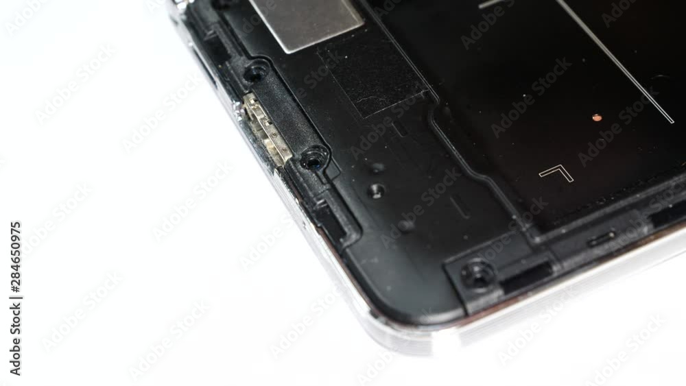 Male human hand disconnecting, putting out battery from phone. Smartphone fixing, technology repairing concept Male human hand disconnecting, putting out battery from phone. Smartphone fixing, technology repairing concept