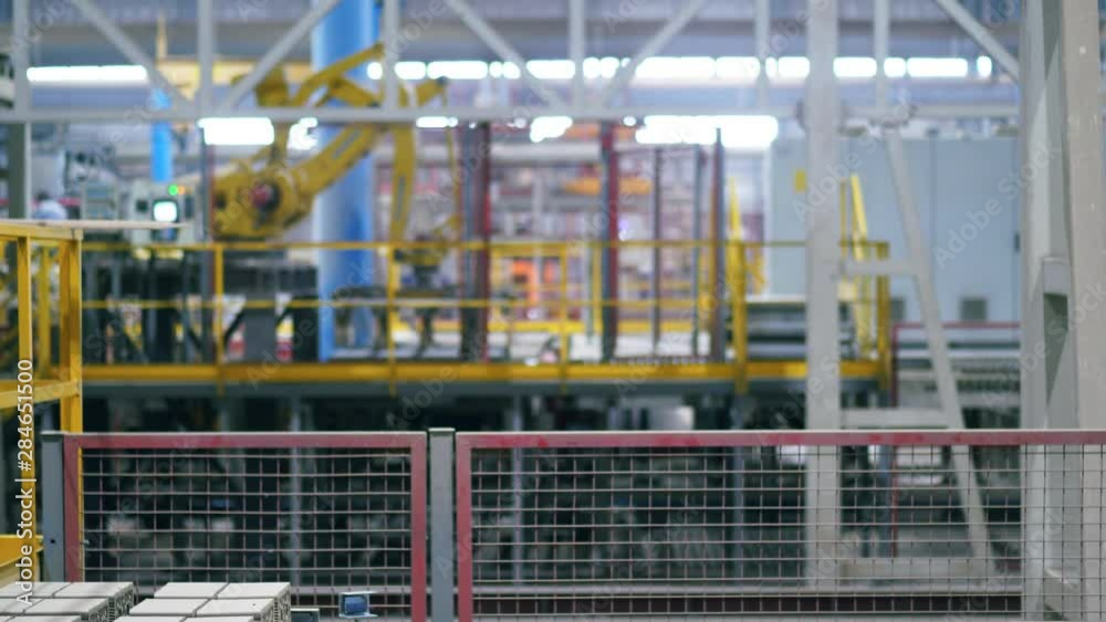 Modern industrial factory. Ceramic products are getting mechanically relocated at the factory Modern industrial factory. Ceramic products are getting mechanically relocated at the factory