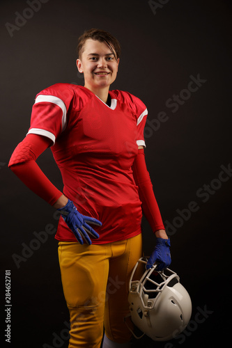Picture of american brunette woman soccer player with helmet in her hand © Sergey