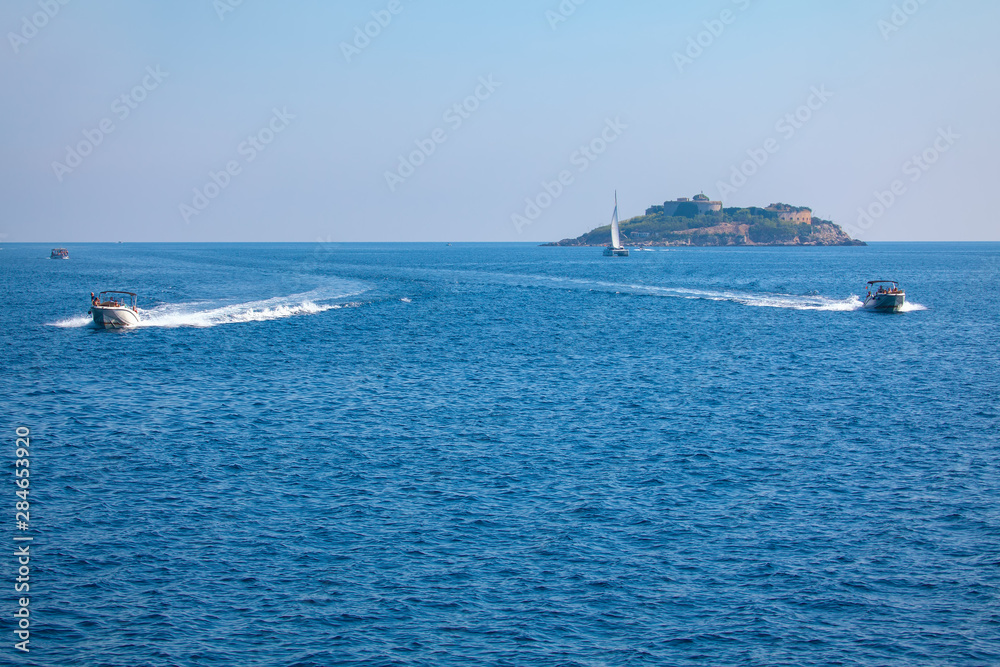 Sailing on motorboats near Mamula island in Adriatic Sea  