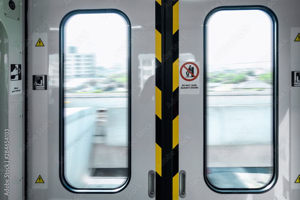 Automatic Metro Skytrain Doorway Inside Vehicle Transport Seat, Electric Security Entrance Door of Public Transportation Train in Urban City While Operating Movement. Passengers Safety System Concept