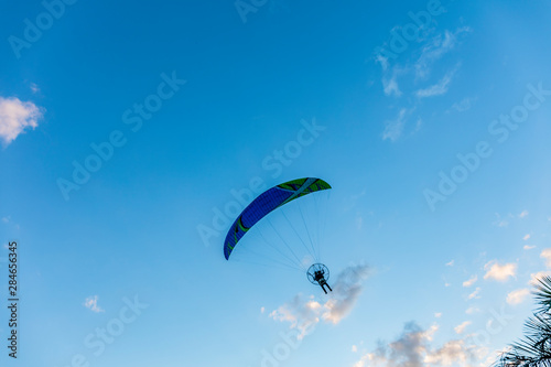 Paragliding in the sky. Tandem paraglider flying over Tiradentes Minas Gerais city and mountains in bright sunny day.
