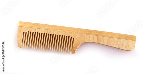 the wooden comb for hair on a white background