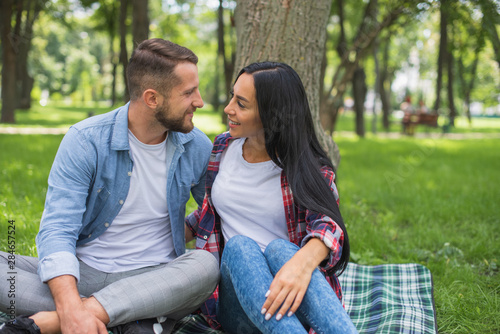 couple in love are resting in the park and hugging