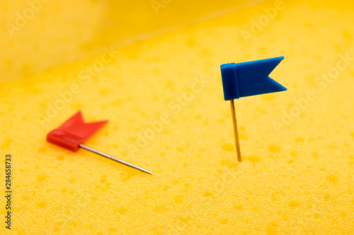 pushpin flag over yellow board photo