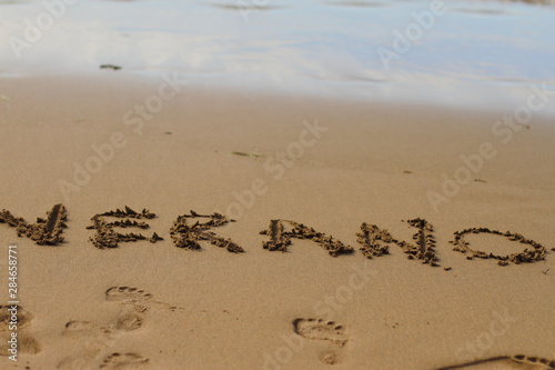 Verano, 2019, word summer is written on the sand 