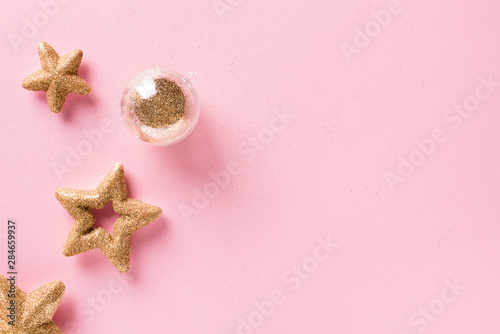 Christmas and holiday pink background with golden stars