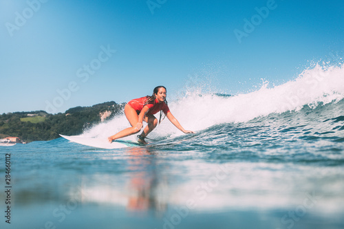 Canvas Print girl surfing photographed from the water, on a sunny day