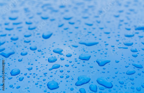 Drops of water on blue surface.