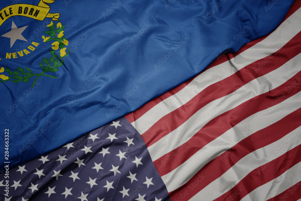Obraz premium waving colorful flag of united states of america and flag of nevada state.