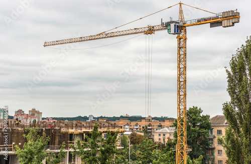 A fragment of the construction of a residential building with a construction crane in the center of Kiev, Ukraine.