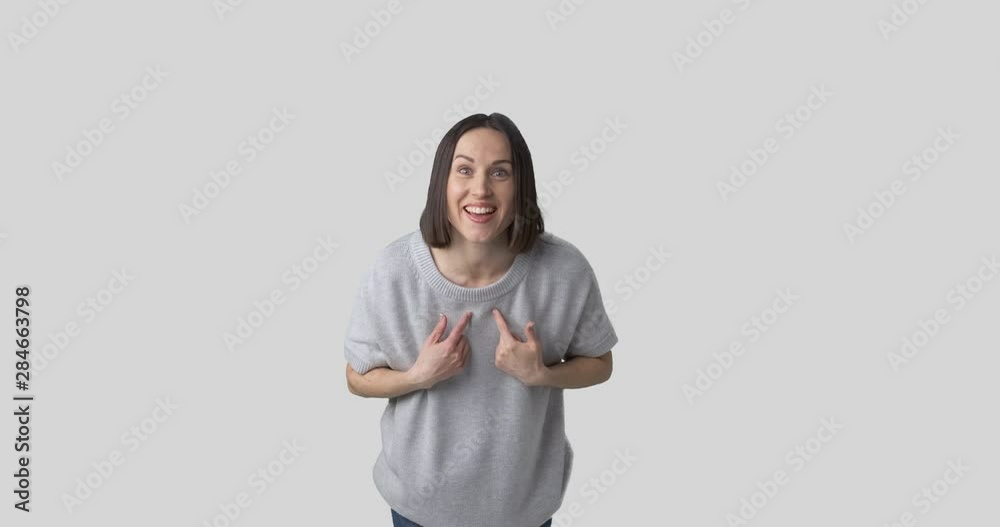 Suspicious and happy young woman waving over white background Suspicious and happy young woman waving over white background