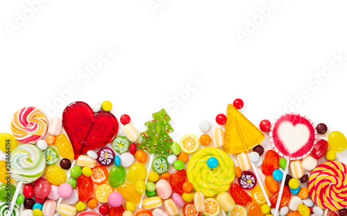 Colorful lollipops and different colorful candy isolated on white