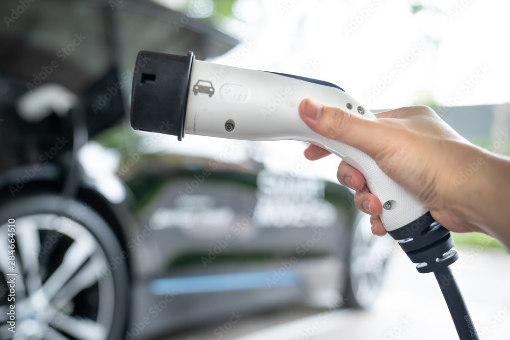 EV Car Charger. Electric car. Charging Station with the power cable. Technology car. Future transport. Recharging. High technology . Transportation EV. Transport EV car. Innovation future. EV Car Charger. Electric car. Charging Station with the power cable. Technology car. Future transport. Recharging. High technology . Transportation EV. Transport EV car. Innovation future.