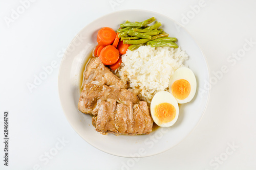 Baked pork ribs with rice, boiled egg and vegetable