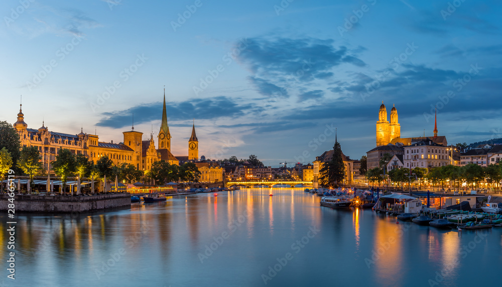 Zurich downtown skyline with Fraumunster and Grossmunster churches at lake zurich at night, Switzerland.