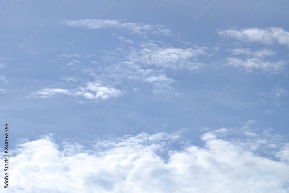 White fluffy clouds against blue sky in bright day for background texture White fluffy clouds against blue sky in bright day for background texture