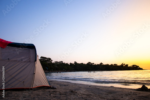 Tourist blue tent on sea beach. Holiday and summer vacation travel concept