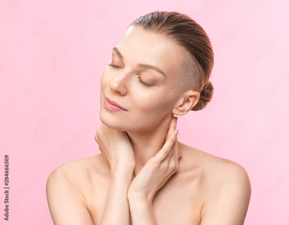Young beauty woman with shaved temple. Studio portrait. Healthcare, skincare concept on the pink background Young beauty woman with shaved temple. Studio portrait. Healthcare, skincare concept on the pink background