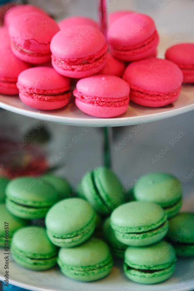 Fototapeta premium Magenta and green colored cookies of lemon and strawberry flavor accompanied by a toy rabbit.