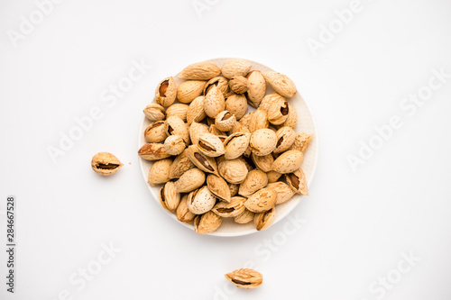 tasty nutritious shell almonds on a white background